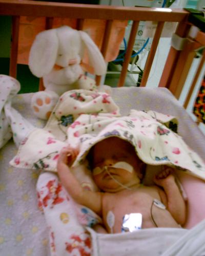 Emily in her crib at the hospital under the warmer